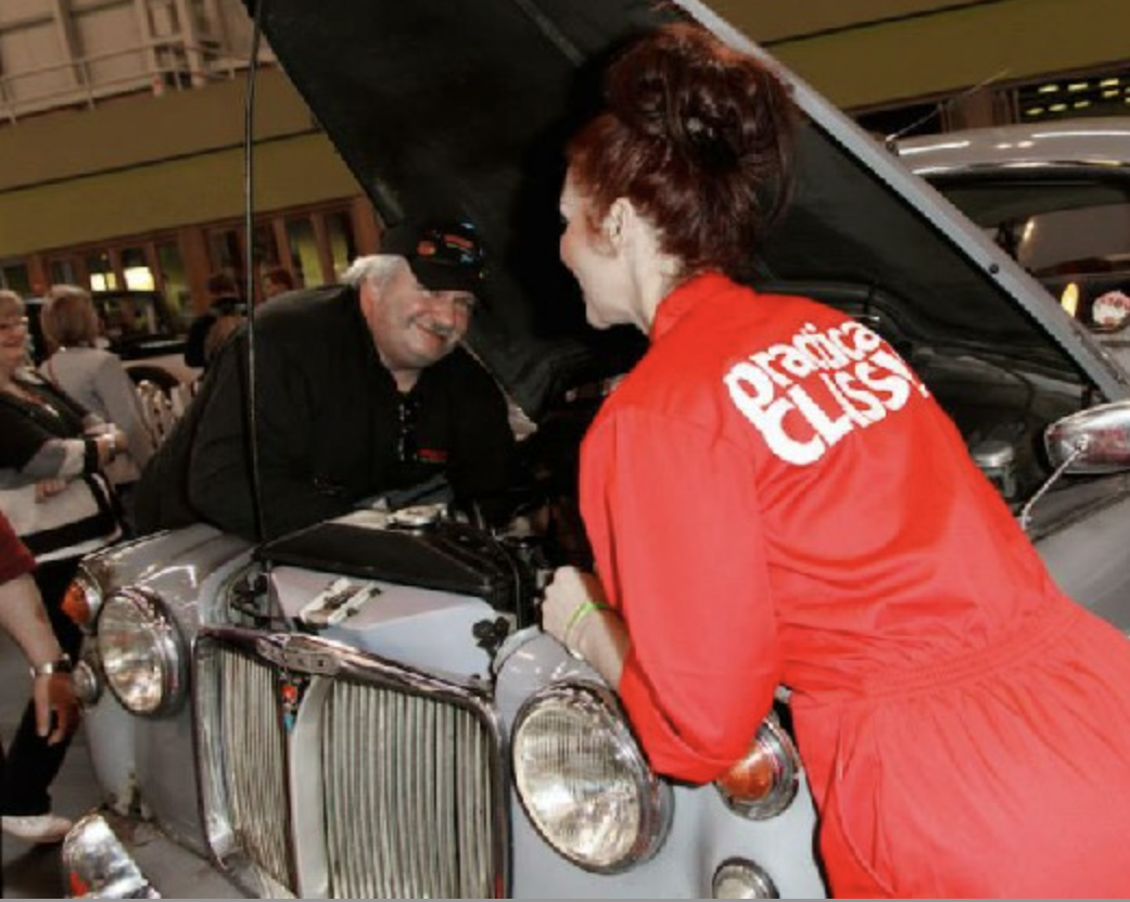 two people fixing a car